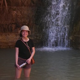 Photo of Francie Diep standing in a pool of water at the Ein Gedi oasis in Israel